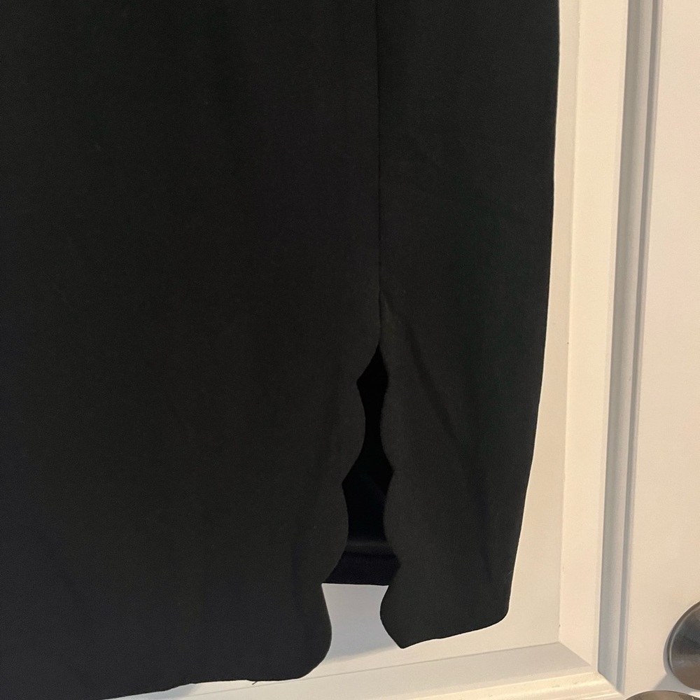 Lulu’s black mini dress with scallop edging.